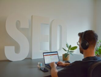 a man sitting in front of a laptop computer