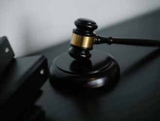 Close-up of a wooden gavel on a desk, symbolizing justice and legal authority.